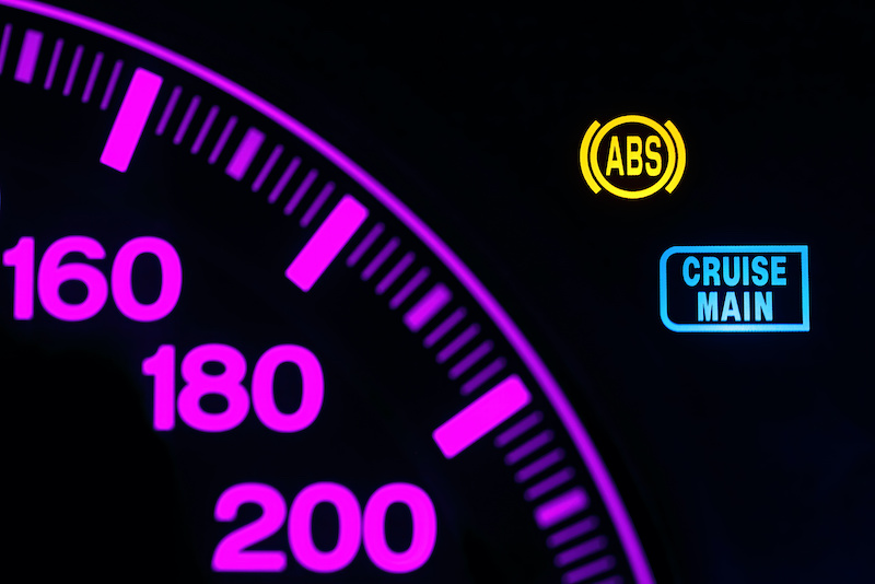 ABS error indicator on car dashboard. ABS warning light, damaged sensor. Illuminated car indicator closeup. Anti-lock braking system (ABS) Warning light on car dashboard