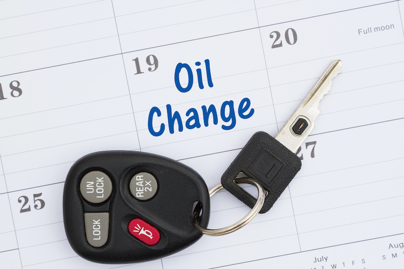 Schedule an oil change message with monthly calendar with car keys and fob