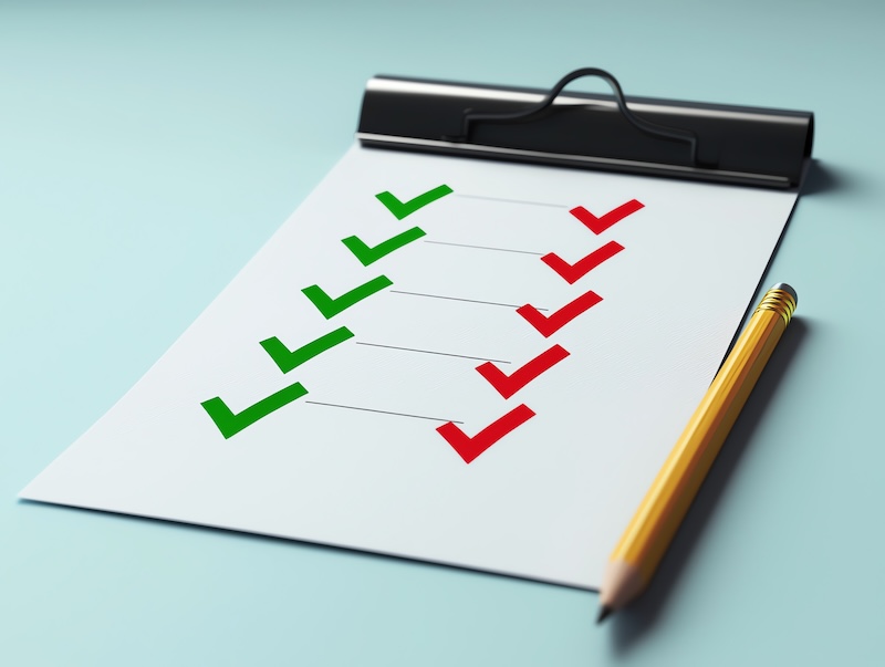 Close-up of a checklist with green and red checkmarks, symbolizing task completion and evaluation on a clipboard. Garden City checklist 