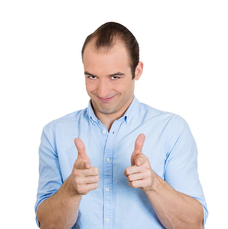 Closeup portrait of young handsome man with two hands guns sign gesture pointing at you camera, isolated on white background. Positive human emotion facial expression feelings, signs and symbols