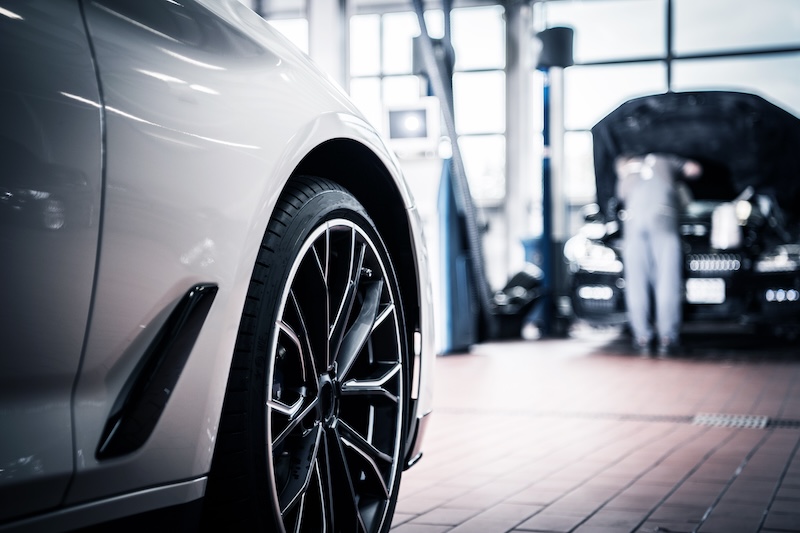 Auto Service and Vehicle Maintenance by Professional Technician in the Background. Automotive Industry. Auto Service Maintenance:auto service,automotive,dealership,transport,car,vehicle,auto,maintenance,engine,repair,transmission,recall,warranty,broken,industry,industrial,worker,technician,car mechanic,worker,job,labor,fix,fixing,horizontal
