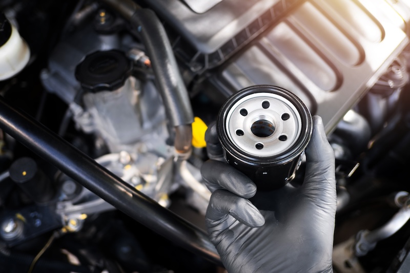 The new car oil filter, automotive spare part, car maintenance concept.